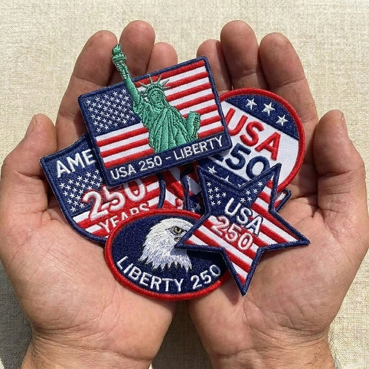 Patriotic 250 Years Of Freedom Patches Held In Hands