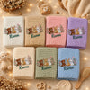 Seven embroidered blanket colors displayed in cozy nursery