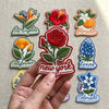 New York Red Rose Embroidered Patch Held By Hand
