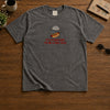 Grey Graphic Shirt Displayed Flat On Rustic Wooden Table