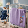 Purple Oliver Grey Blanket Draped Over A Nursery Crib