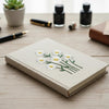 Beige Embroidered Daisy Notebook Styled With Fountain Pen Supplies