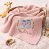 Pink Rosie Booties Blanket Styled With Colorful Baby Toys