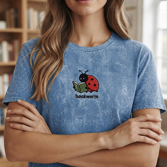 Woman Wearing Blue Bookworm Ladybug Embroidered Mineral Wash Tee