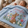 Personalized light blue bunny blanket covering sleeping newborn
