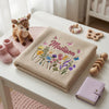 Beige Butterfly Bloom Blanket Folded On A Wooden Table