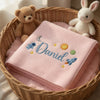 Pink Daniel Space Blanket Displayed With Plush Nursery Toys