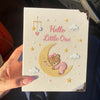 Beige Embroidered Baby Notebook Held In Natural Sunlight