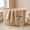 Beige Embroidered Astronaut Blanket Displayed In Nursery Basket
