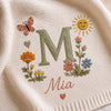 Close Up Embroidery Of Floral Initial M With Name Mia