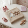 Beige Daisy Goose Blanket Displayed With Baby Keepsake Accessories