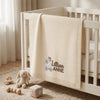 Cream Personalized Daisy Goose Blanket Draped Over Nursery Crib