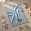 Light Blue Daisy Goose Blanket Surrounded By Soft Nursery Toys