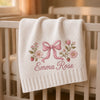 White personalized baby blanket with pink bow and floral embroidery