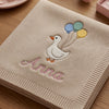 Closeup Of Beige Blanket Embroidered With Goose And Anna