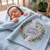 Newborn In Cradle Wrapped In Light Blue Knit Blanket 
