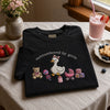 Folded Black Outnumbered By Girls Tee With Pink Baby Toys