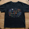 Front View Black Floral Science Tee On Wooden Table