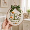 Closeup Embroidered Initial Ornament With Hummingbird And Wildflowers