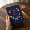 Handheld Navy Notebook Showcases Colorful Floral Wreath Embroidery