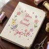 Beige Floral Notebook Displayed With Embroidery Scissors And Threads