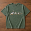 Moss Goose Family Tee Displayed Flat On Wooden Surface