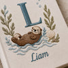 Close Up Of Embroidered Sea Otter Design With Letter L