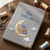 Gray Moon Bear Notebook Surrounded By Colorful Sewing Supplies