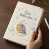 Beige Little Star Notebook Held On Wooden Desk