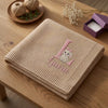 Beige Bunny Name Blanket Folded On Rustic Wooden Table