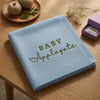 Light Blue Personalized Baby Blanket Folded On Wooden Table