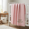 Pink Personalized Baby Blanket Hanging On Crib