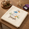 Cream Folded Duck Blanket Flat Lay On Wooden Table
