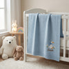 Light Blue Embroidered Duck Blanket Draped On Crib Rail
