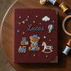 Maroon Lucas Keepsake Featuring Teddy Bear And Nursery Toys