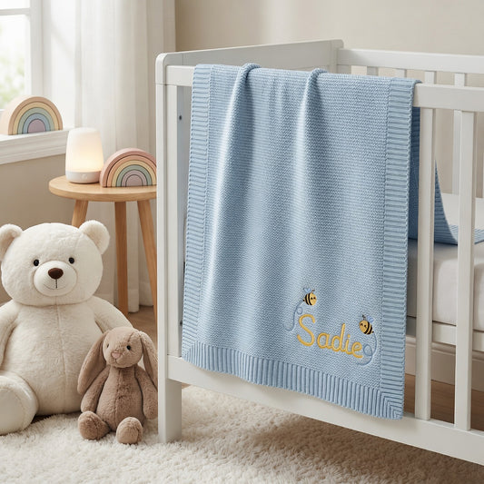 Personalized Embroidered Blue Baby Blanket On Nursery Crib