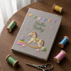 Gray Hello Baby Notebook Styled Among Pastel Thread Spools