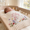 Cream Goose Blanket In Baby Crib