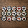 Fifteen Regional Barbecue Club Emblems Displayed On Rustic Wood