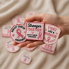Hand Holding Three Pink Breast Cancer Awareness Patches