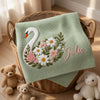 Mung Bean Julie Swan Blanket Draped Over Wicker Basket