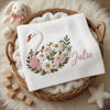 White Floral Swan Blanket Displayed In Round Nursery Basket