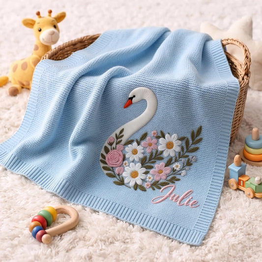 Light Blue Floral Swan Blanket Draped Over Wicker Basket