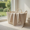 Beige Olivia Blanket Displayed Over Basket Beside Garden Window