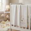 White Sweet Dreams Blanket Draped Across A Nursery Crib