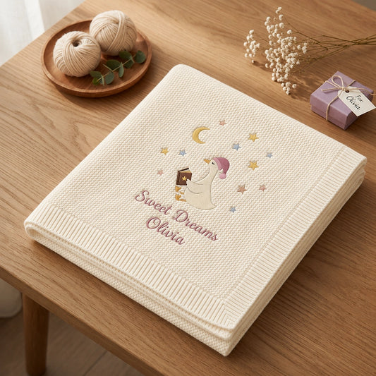 Cream Personalized Goose Blanket Folded Beside A Gift Box