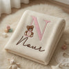 Cream Noor Teddy Blanket Displayed Beside Baby Toys