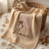 Beige Noor Teddy Blanket Draped Over Wicker Basket