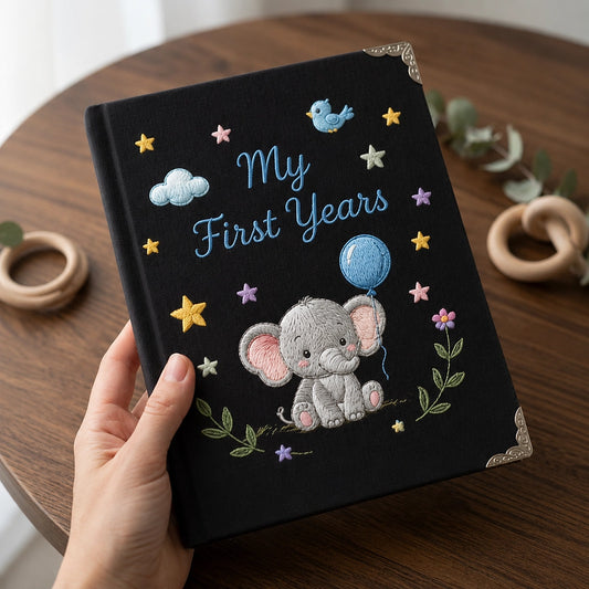 Black Personalized Baby Notebook Held Above Wooden Table