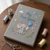 Gray Elephant Notebook Surrounded By Colorful Thread Spools